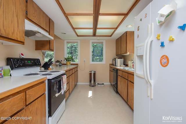 4450 Trapline Dr, Anchorage, AK 99516 - kitchen featuring white appliances, under cabinet range hood, light countertops, and brown cabinetry