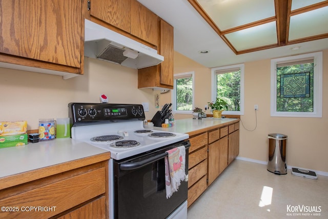 4450 Trapline Dr, Anchorage, AK 99516 - kitchen featuring range with electric cooktop, under cabinet range hood, light countertops, and brown cabinets