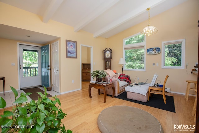 4450 Trapline Dr, Anchorage, AK 99516 - living room featuring beamed ceiling, light wood-style flooring, a chandelier, and healthy amount of natural light