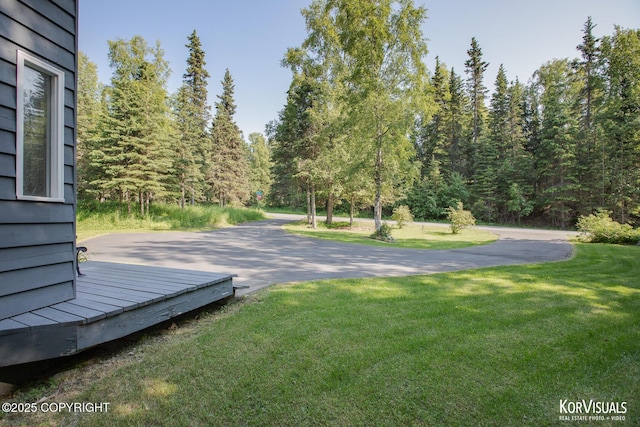 4450 Trapline Dr, Anchorage, AK 99516 - view of grassy yard with a deck