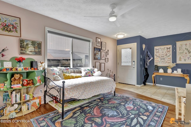 1124 Fred Cir, Anchorage, AK 99515 - bedroom featuring wood finished floors, a ceiling fan, and a textured ceiling