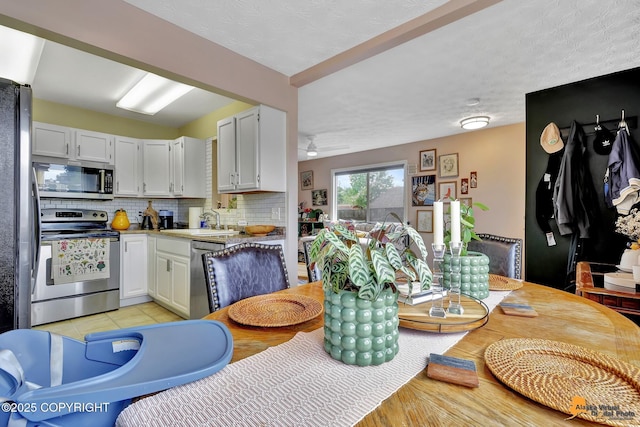 1124 Fred Cir, Anchorage, AK 99515 - kitchen with appliances with stainless steel finishes, tasteful backsplash, ceiling fan, light countertops, and white cabinets