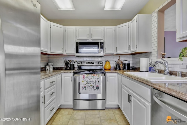 1124 Fred Cir, Anchorage, AK 99515 - kitchen featuring stainless steel appliances, white cabinetry, and decorative backsplash