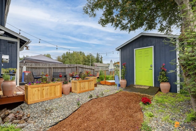 1124 Fred Cir, Anchorage, AK 99515 - view of yard with a vegetable garden and a storage shed