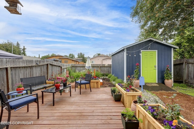 1124 Fred Cir, Anchorage, AK 99515 - wooden terrace with a fenced backyard, an outdoor living space, and a storage unit