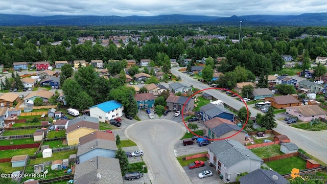 1124 Fred Cir, Anchorage, AK 99515 - aerial view of residential area featuring a mountainous background and a heavily wooded area