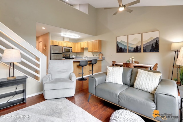 12231 Johns Rd # 2, Anchorage, AK 99515 - living area featuring dark wood-style flooring, ceiling fan, stairs, a high ceiling, and recessed lighting