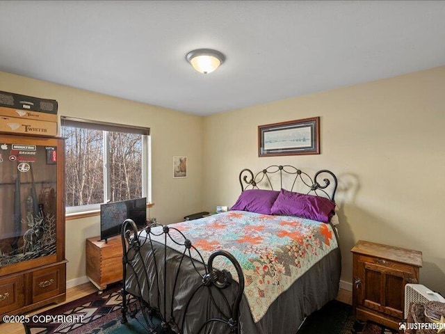 3872 N Charley Dr, Wasilla, AK 99654 - bedroom with baseboards and wood finished floors