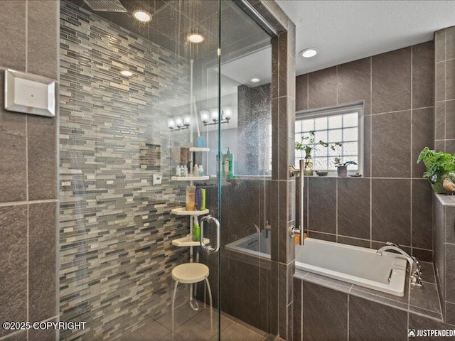 3872 N Charley Dr, Wasilla, AK 99654 - bathroom featuring a shower stall, tile walls, a garden tub, tile patterned flooring, and recessed lighting