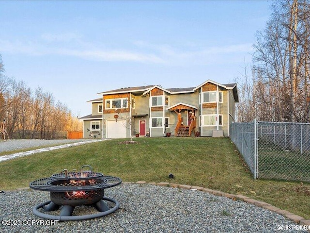 3872 N Charley Dr, Wasilla, AK 99654 - view of front facade featuring a fire pit, an attached garage, and driveway