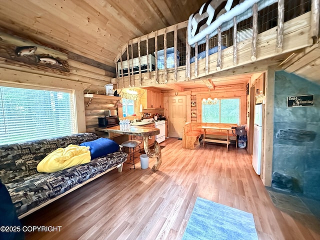 15700 Wild Salmon Way, Ninilchik, AK 99639 - living room with wooden ceiling, light wood-type flooring, rustic walls, and high vaulted ceiling