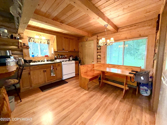 15700 Wild Salmon Way, Ninilchik, AK 99639 - kitchen with gas range gas stove, a wood ceiling with exposed beams, a chandelier, light wood-type flooring, and hanging light fixtures