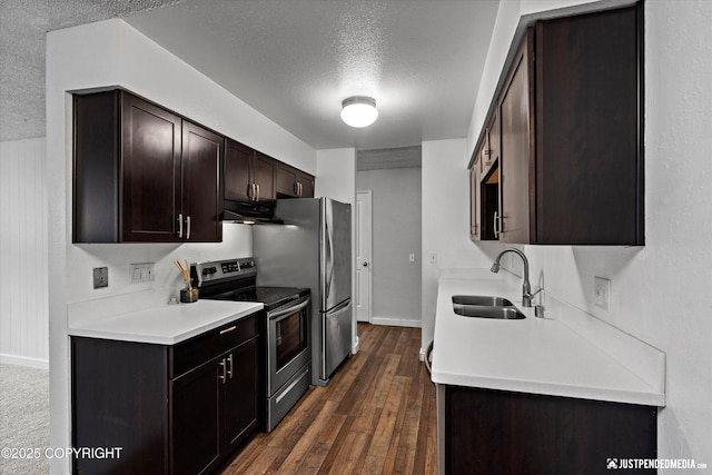 3100 Ward Pl Unit 6, Anchorage, AK 99517 - kitchen with electric stove, a textured ceiling, dark brown cabinets, light countertops, and dark wood finished floors