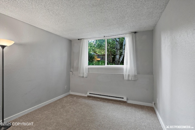 3100 Ward Pl Unit 6, Anchorage, AK 99517 - spare room with baseboard heating, a textured ceiling, and carpet flooring