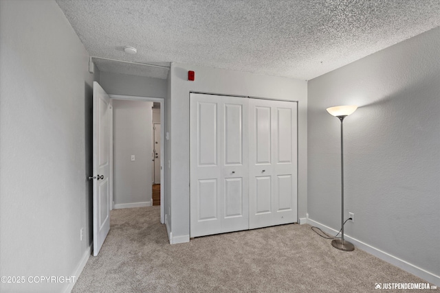 3100 Ward Pl Unit 6, Anchorage, AK 99517 - unfurnished bedroom with light colored carpet, a closet, and a textured ceiling