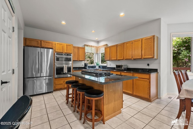 250 Botanical Cir, Anchorage, AK 99515 - kitchen with appliances with stainless steel finishes, light tile patterned floors, a center island, a kitchen breakfast bar, and recessed lighting