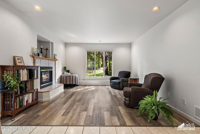 250 Botanical Cir, Anchorage, AK 99515 - sitting room featuring wood finished floors, a fireplace, and recessed lighting