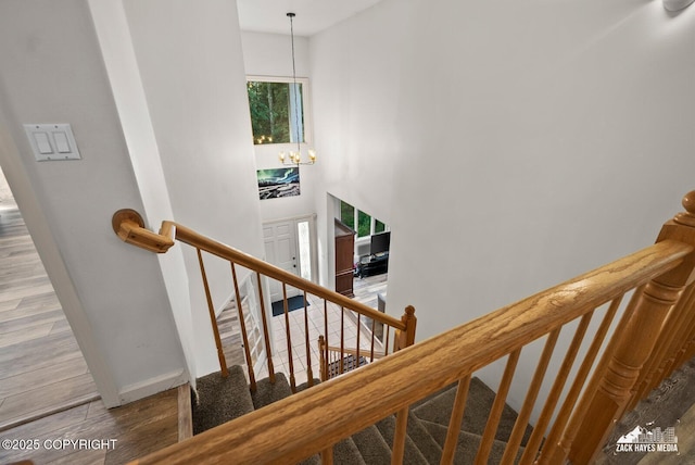250 Botanical Cir, Anchorage, AK 99515 - stairway featuring a chandelier and wood finished floors