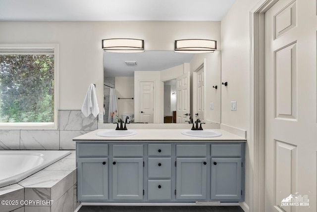 250 Botanical Cir, Anchorage, AK 99515 - bathroom featuring double vanity, a garden tub, and a shower