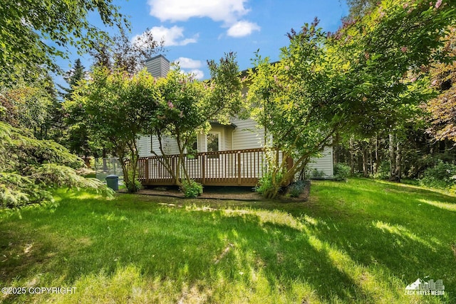 250 Botanical Cir, Anchorage, AK 99515 - back of property featuring a deck, a lawn, and a chimney