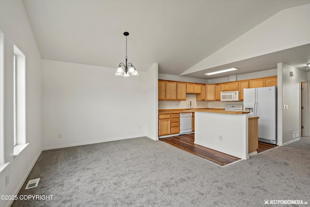 221 Whisper Ridge Cir # A, Anchorage, AK 99504 - kitchen featuring white appliances, lofted ceiling, dark colored carpet, a chandelier, and a center island