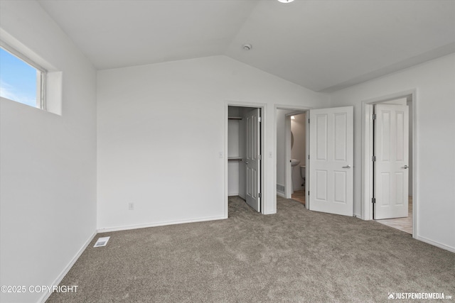 221 Whisper Ridge Cir # A, Anchorage, AK 99504 - unfurnished bedroom with carpet floors, lofted ceiling, and a spacious closet