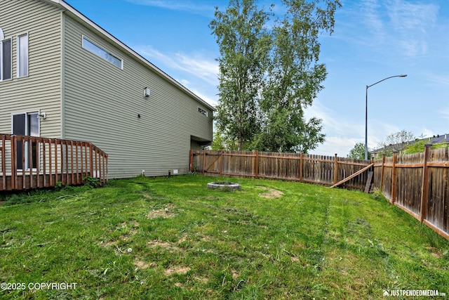 221 Whisper Ridge Cir # A, Anchorage, AK 99504 - fenced backyard with a fire pit and a deck