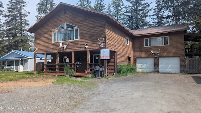 3411 Eagle Ave, Valdez, AK 99686 - rustic home with asphalt driveway and an attached garage