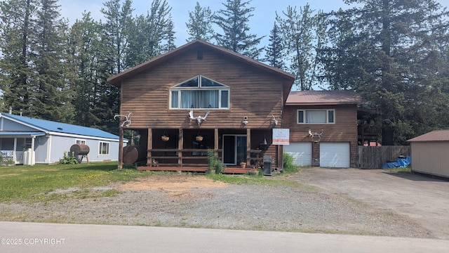 3411 Eagle Ave, Valdez, AK 99686 - view of front facade with a porch, a garage, and asphalt driveway