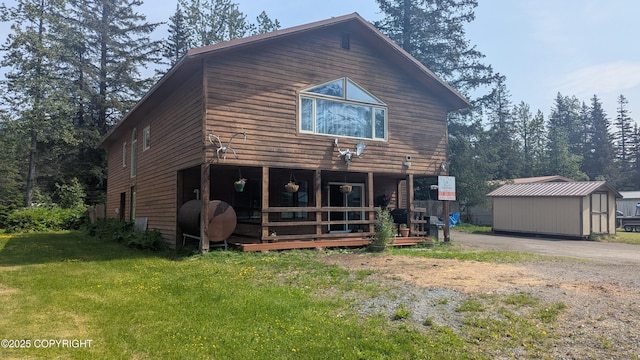 3411 Eagle Ave, Valdez, AK 99686 - back of property featuring oil tank, an outbuilding, and a yard