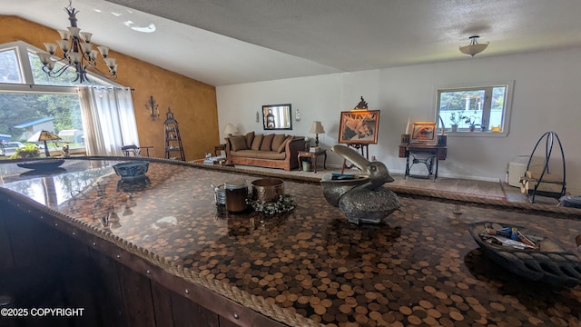 3411 Eagle Ave, Valdez, AK 99686 - kitchen with a chandelier, vaulted ceiling, carpet, and dark stone counters