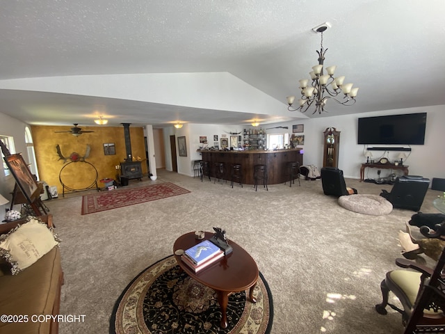 3411 Eagle Ave, Valdez, AK 99686 - carpeted living area featuring lofted ceiling, a wood stove, a chandelier, and bar