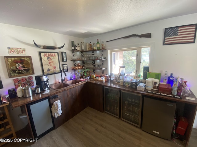 3411 Eagle Ave, Valdez, AK 99686 - indoor bar with wine cooler, wood finished floors, a textured ceiling, and fridge