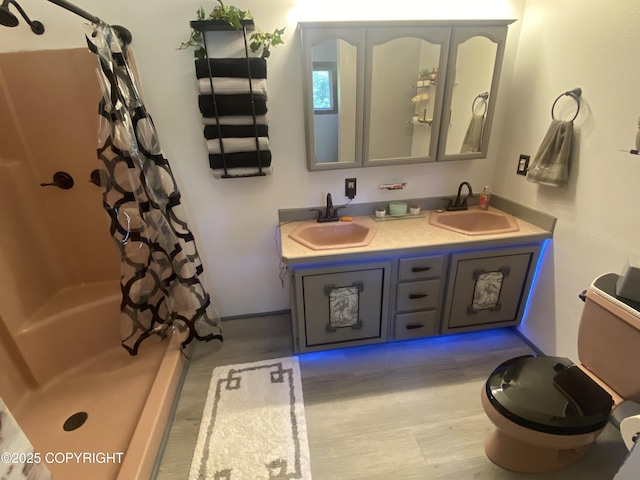 3411 Eagle Ave, Valdez, AK 99686 - bathroom featuring double vanity, wood finished floors, and shower / bathtub combination with curtain