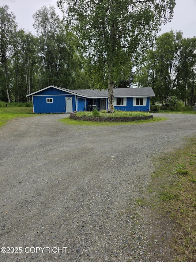 4100 W Peterson Bay Ct, Wasilla, AK 99623 - view of front facade with dirt driveway and view of scattered trees