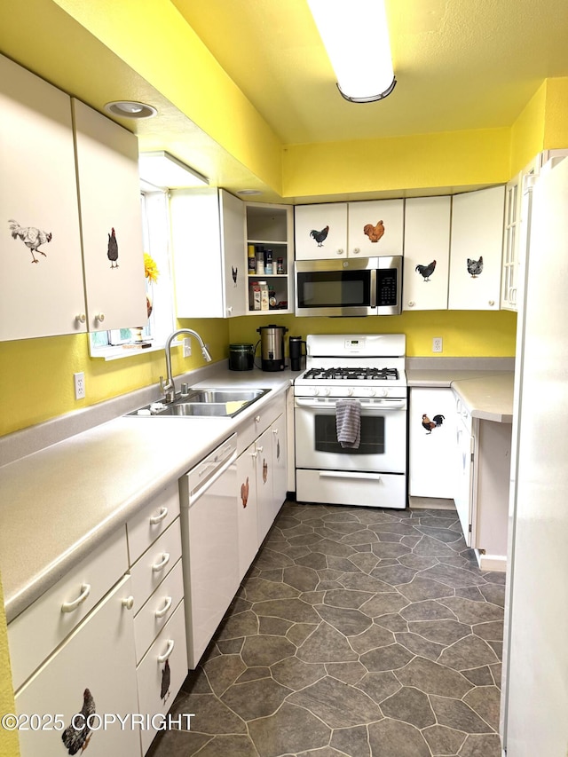 4100 W Peterson Bay Ct, Wasilla, AK 99623 - kitchen with white appliances, white cabinetry, light countertops, dark stone finish flooring, and glass insert cabinets