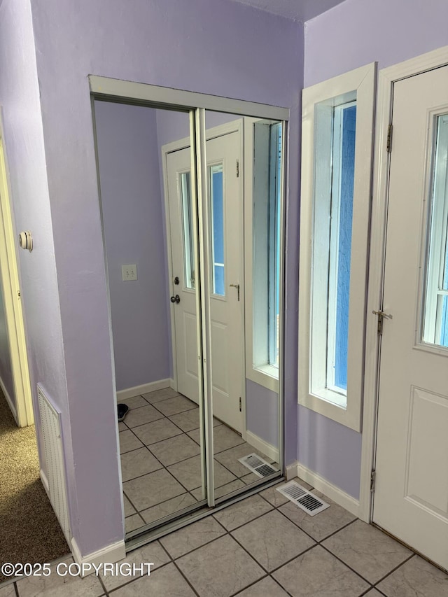 4100 W Peterson Bay Ct, Wasilla, AK 99623 - entryway with light tile patterned flooring and healthy amount of natural light