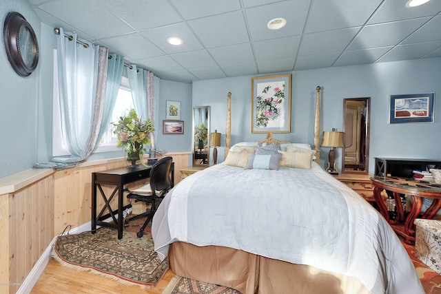 1240 Chinook Dr, Kenai, AK 99611 - bedroom featuring light wood finished floors, recessed lighting, a wainscoted wall, a paneled ceiling, and wood walls