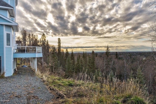 1240 Chinook Dr, Kenai, AK 99611 - yard at dusk featuring a wooded view