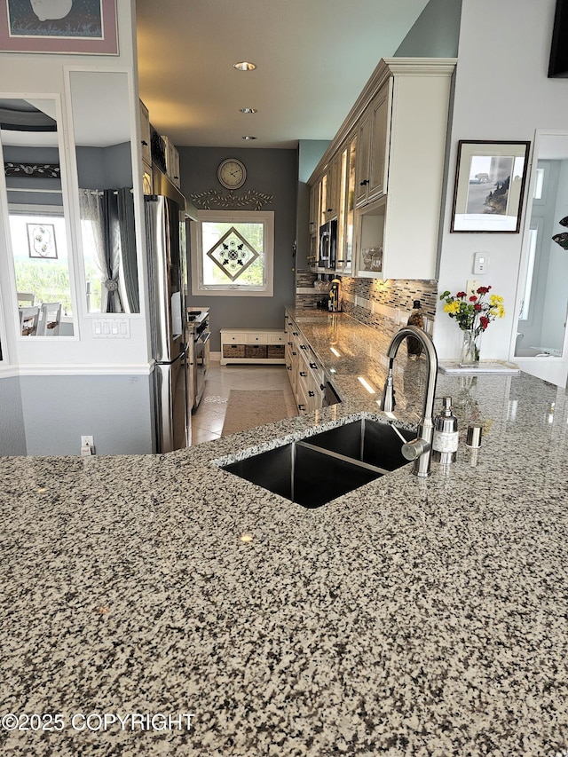 1240 Chinook Dr, Kenai, AK 99611 - kitchen featuring light stone counters, appliances with stainless steel finishes, backsplash, and recessed lighting