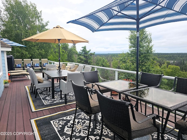 1240 Chinook Dr, Kenai, AK 99611 - deck featuring outdoor dining area and a view of trees