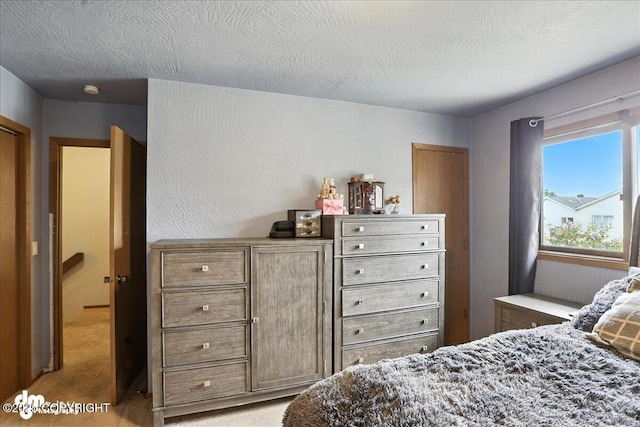 6260 Newt Dr, Anchorage, AK 99507 - bedroom featuring light carpet and a textured ceiling