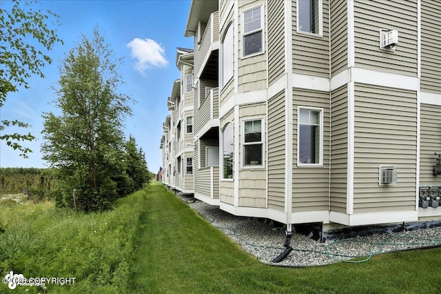 11351 Discovery View Dr # 106, Anchorage, AK 99515 - view of home's exterior with a lawn
