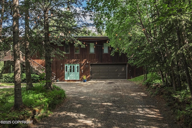11851 Nebesna Dr, Anchorage, AK 99507 - rustic home with driveway, an attached garage, and stairs