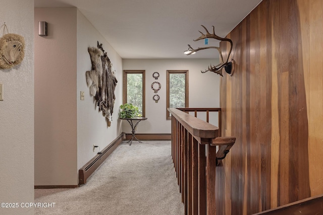 11851 Nebesna Dr, Anchorage, AK 99507 - hallway featuring an upstairs landing, light colored carpet, and baseboard heating