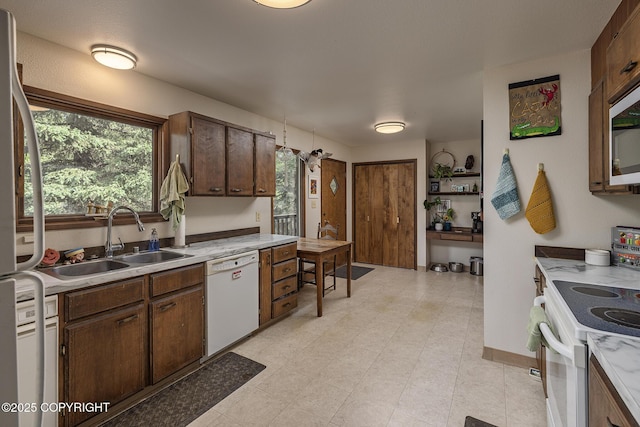 11851 Nebesna Dr, Anchorage, AK 99507 - kitchen with white appliances, light countertops, and dark brown cabinets