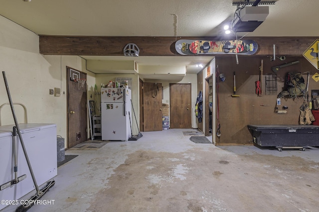 11851 Nebesna Dr, Anchorage, AK 99507 - garage featuring freestanding refrigerator, refrigerator, a workshop area, and a garage door opener