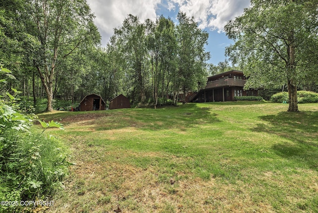 11851 Nebesna Dr, Anchorage, AK 99507 - view of green lawn featuring a shed and a wooden deck