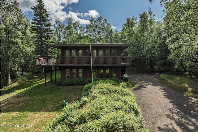 11851 Nebesna Dr, Anchorage, AK 99507 - view of front facade featuring a deck, a front yard, and asphalt driveway
