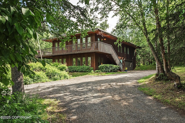11851 Nebesna Dr, Anchorage, AK 99507 - view of front facade featuring driveway, a deck, and stairs
